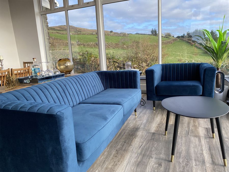 Slender navy blue sofas in a spacious living room