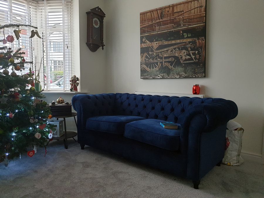 Blue quilted sofa for three people Chesterfield