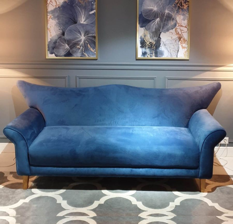 Camelback sofa in blue fabric
