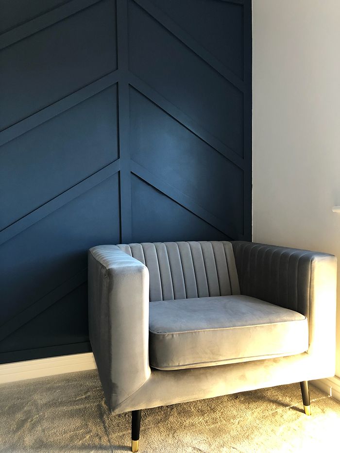 Slender gray armchair by Rachel